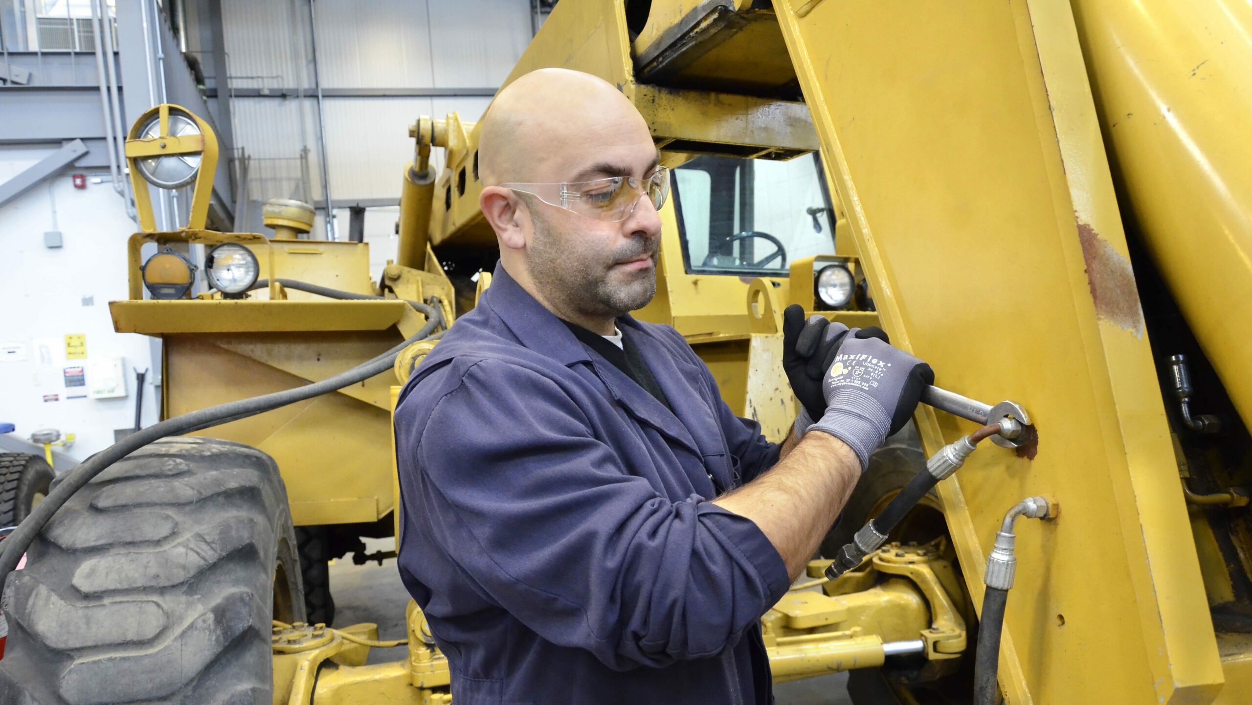 man maintaining tractor